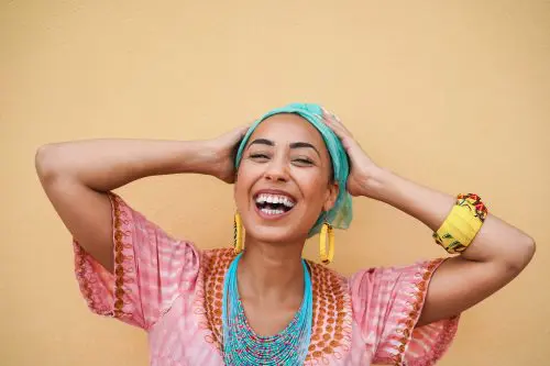 Portrait of happy black young woman in traditional african dress