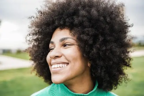 Young hispanic girl smiling outdoor - Focus on face
