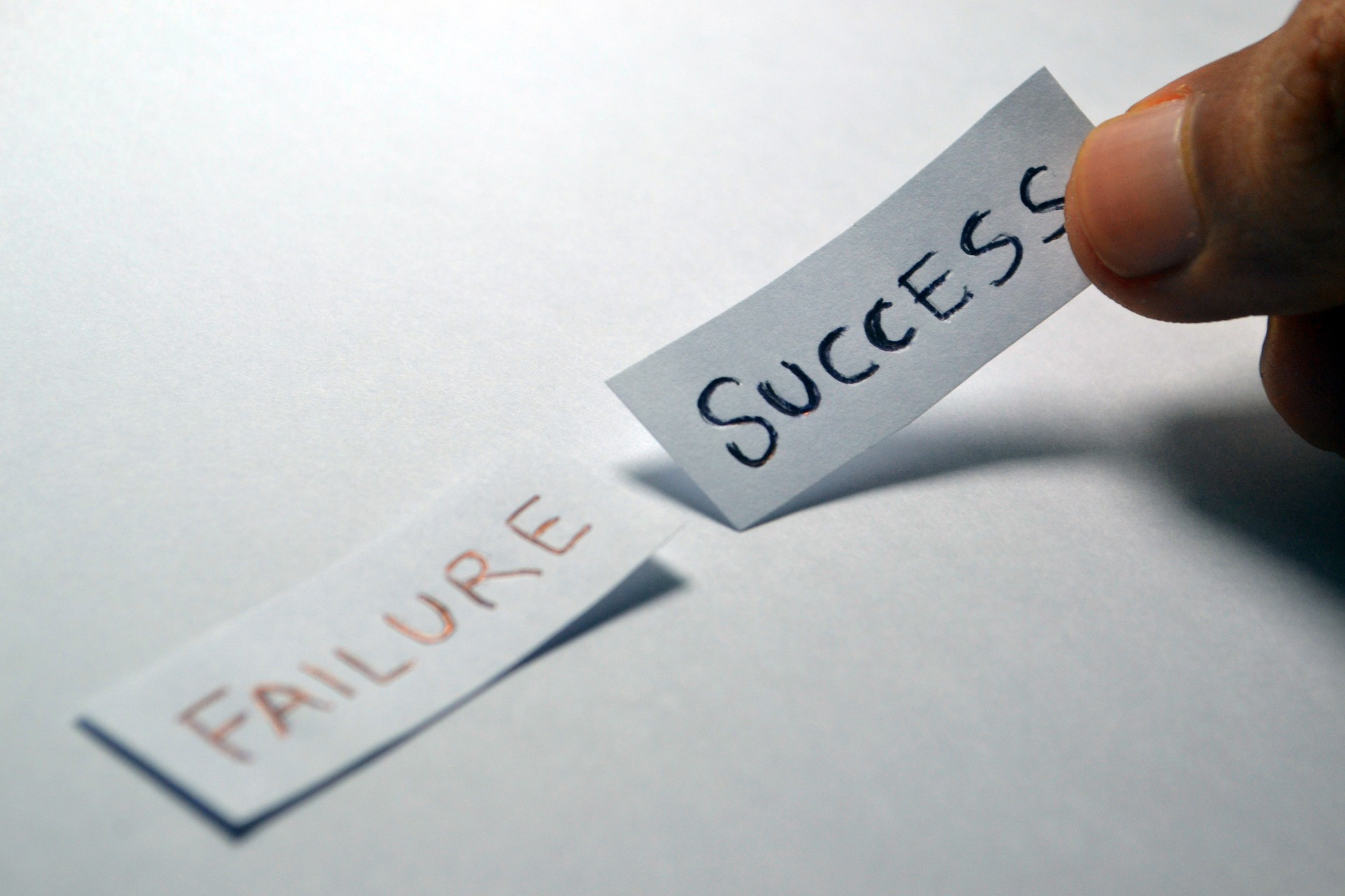 two pieces of paper with the words failure and success