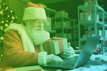 father christmas with present and laptop