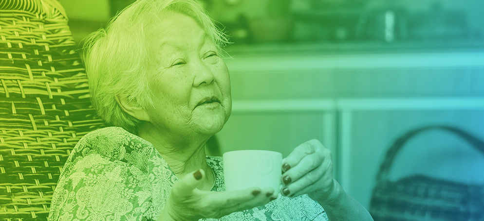 An image of an elderly Japanese woman drinking a cup of tea