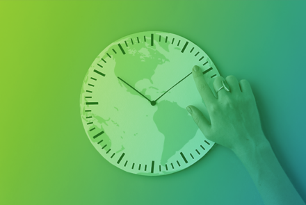 An image of a hand on a clock with a globe overlay