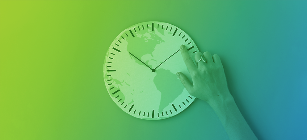 An image of a hand on a clock with a globe overlay