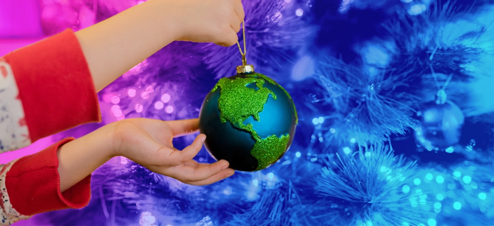 A person holding a globe Christmas bauble