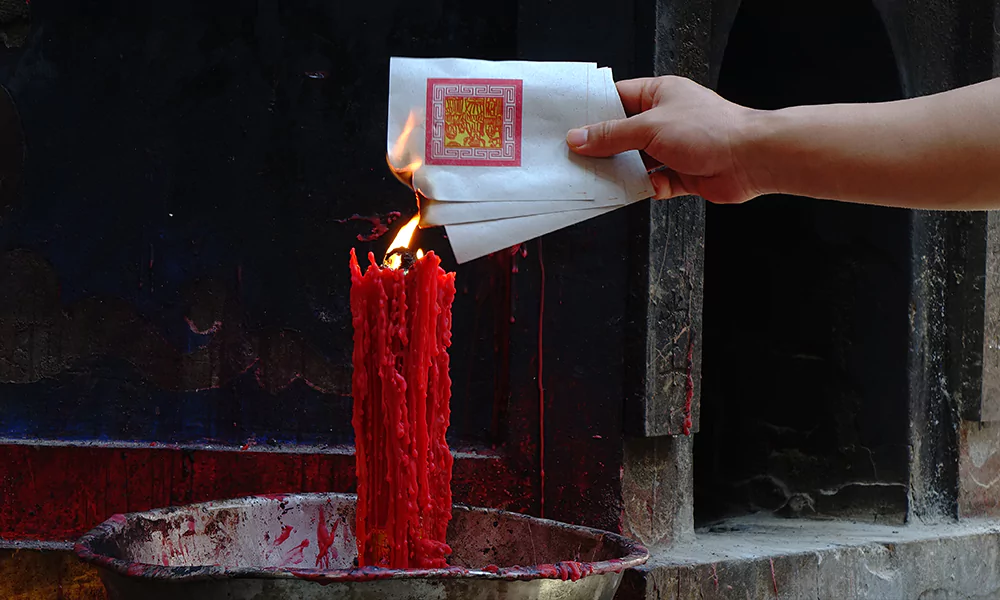 burning notes with a red candle