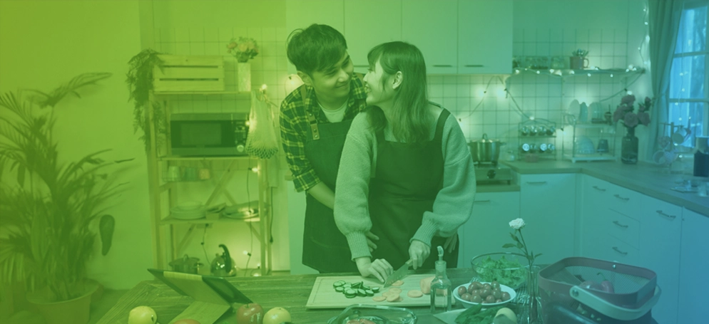 A couple cooking a Valentine's Day dinner together in their kitchen