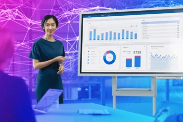 A woman presenting an analytics data board in a corporate meeting