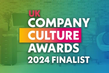The logo for the UK Company Culture Awards with a collection of office furniture in the background