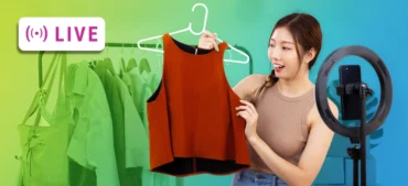 A Chinese woman showing the camera a shirt for sale on a shopping live stream.