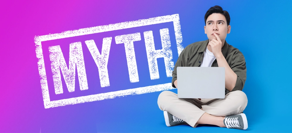 A man on a laptop with the word 'Myth' in the background