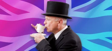 man in a top hat drinking tea in front of the Union Jack flag