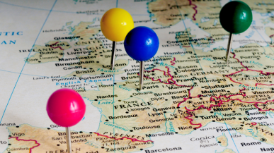 A map with different coloured pins in different countries.
