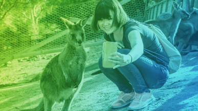A woman taking a selfie with a baby kangaroo