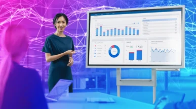 A woman presenting an analytics data board in a corporate meeting