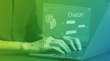 A person typing on a laptop showing a ChatGPT window.