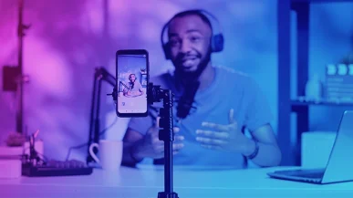 A man recording a TikTok video at a desk
