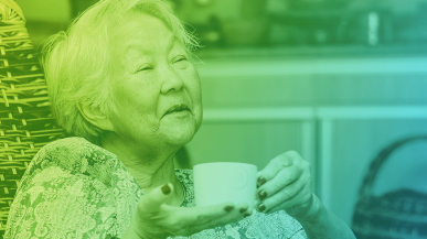 An image of an elderly Japanese woman drinking a cup of tea