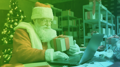 father christmas with present and laptop