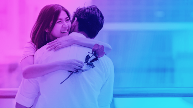 woman hugging a man with a flower in her hand