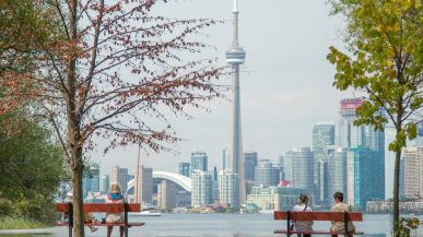 large cityscape and two people on bench