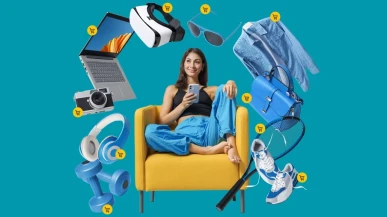 A woman sits on an armchair with her phone whilst products fly around her
