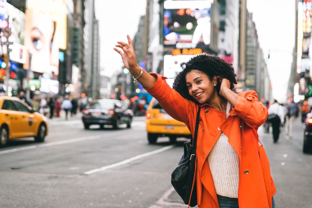 A woman hailing a taxi in New York
