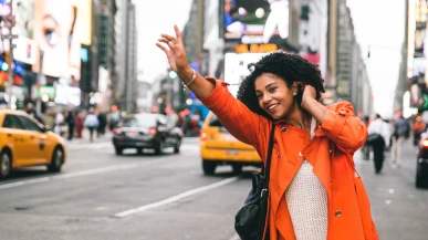 A woman hailing a taxi in New York
