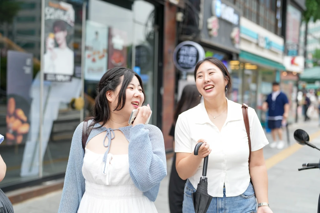 Two South Korean women walking down a street