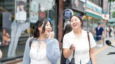 Two South Korean women walking down a street