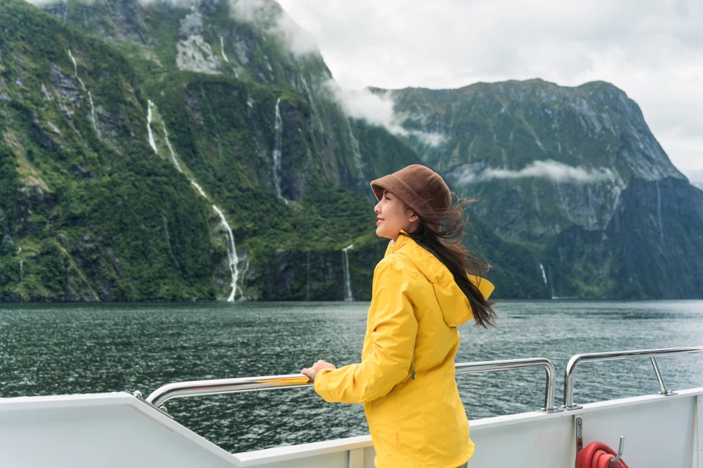A woman on a ferry to visit Milford Sound (Piopiotahi)