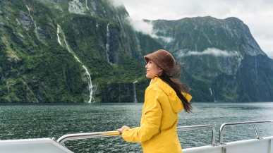 A woman on a ferry to visit Milford Sound (Piopiotahi)