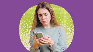 A woman looking at her phone with concern