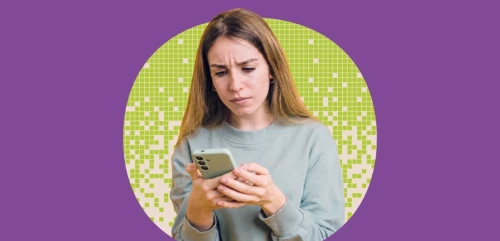 A woman looking at her phone with concern